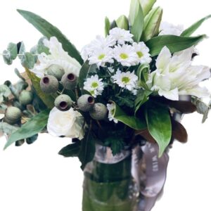 Oriental lily with daisy roses and gum nuts in vase